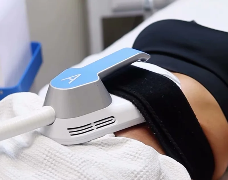 EMS body sculpting applicator strapped onto a client's abdomen during a muscle toning session at Vianka Med Spa