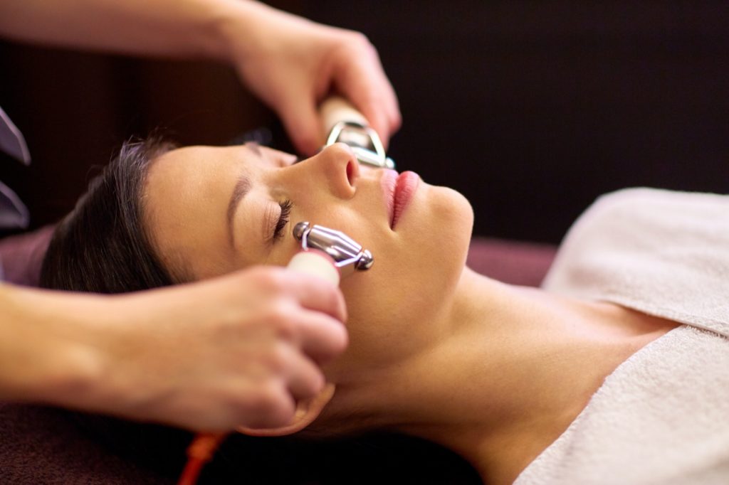 Woman Having Hydradermie Facial Treatment in Spa