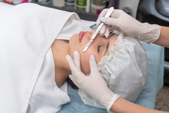 skin treatment with the dermaplaning technique performed with a scalpel by a beautician